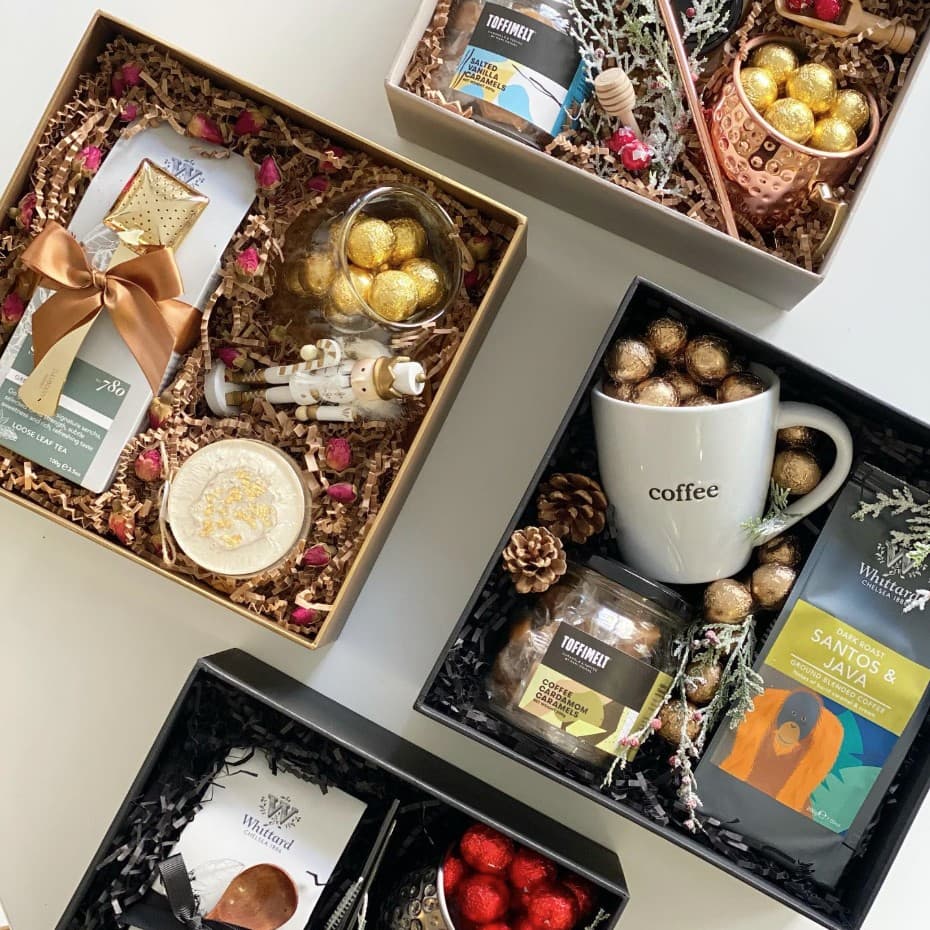 Four curated gift boxes with TOFFIMELT caramels, coffee, tea, and festive details