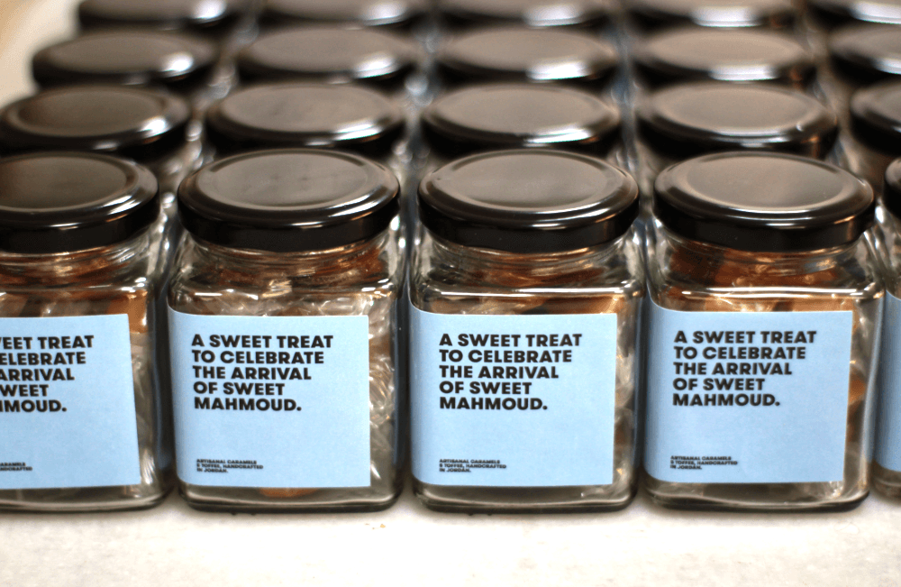 Rows of caramel jars with custom printed celebration labels